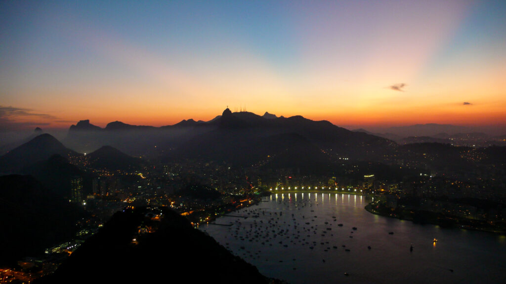 Sunset view from the Sugarhead in Rio de Janeiro showing the famous Jesus Statue in the Mountain Range - 2008